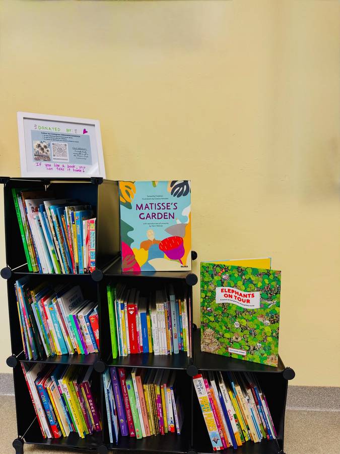 Mini-library bookshelf stocked with children’s books