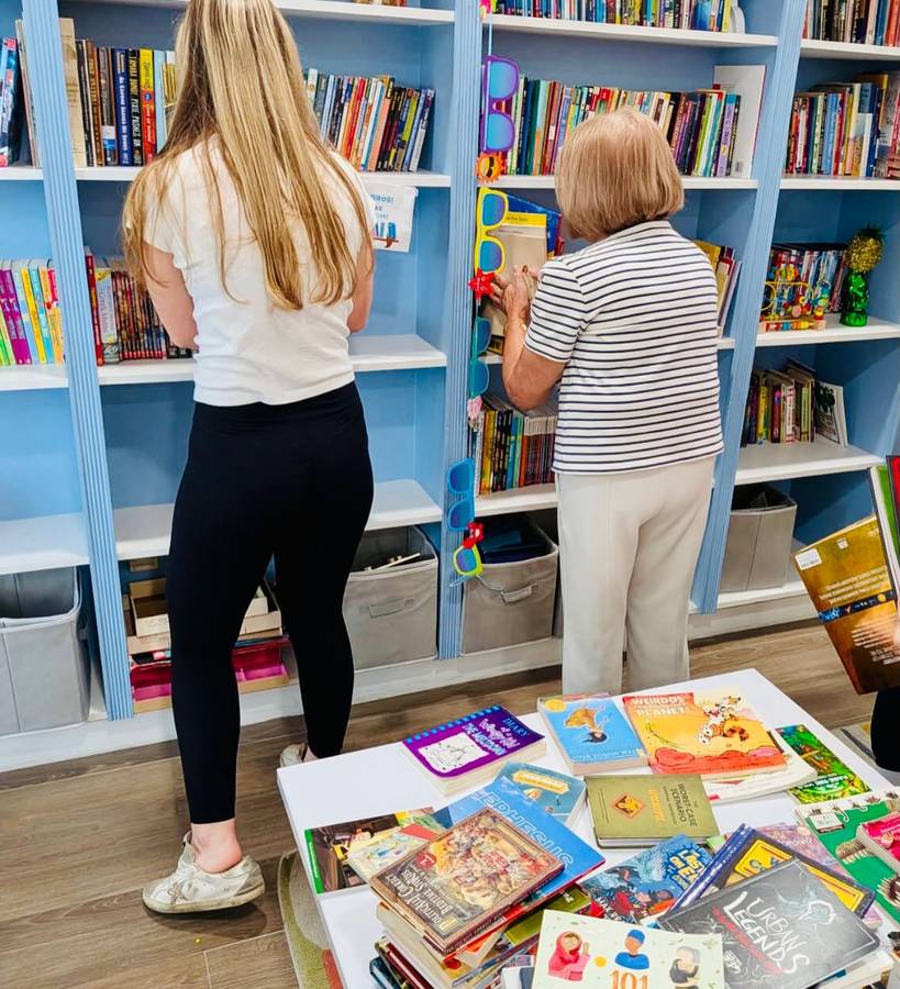 Shelving donated books at Kristi House