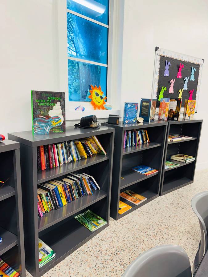 Row of stocked bookshelves at Legion Park Community Center